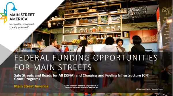 Welcome screen for the DOT funding opportunities webinar. Text reads "Federal Funding Opportunities for Main Streets: Safe Streets and Roads for All and Charging and Fueling Infrastructure Grant Program" with the Main Street America logo
