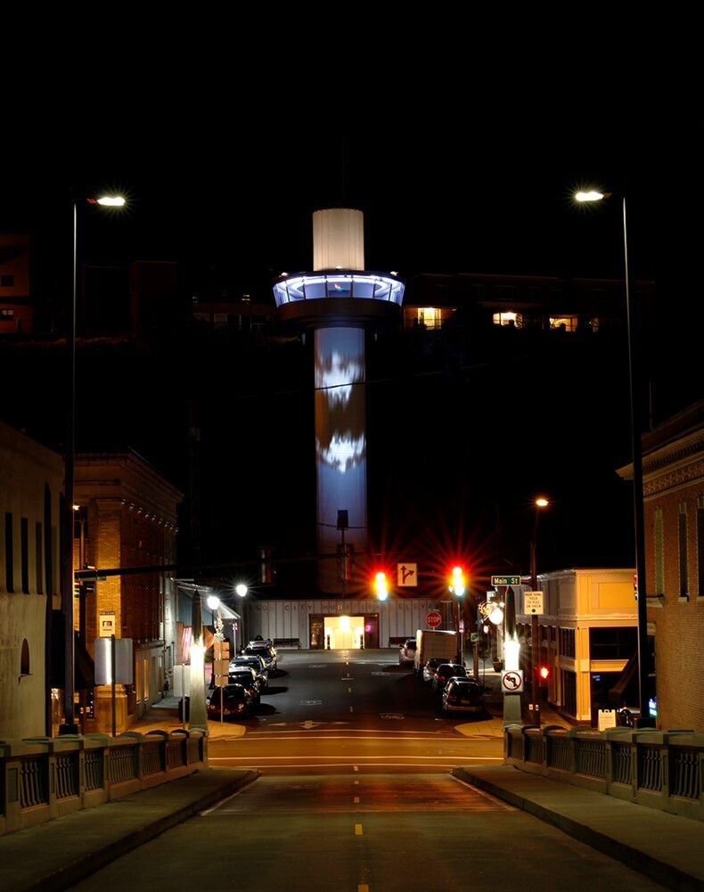 The illuminated tower of the municipal elevator shines above Oregon City at night