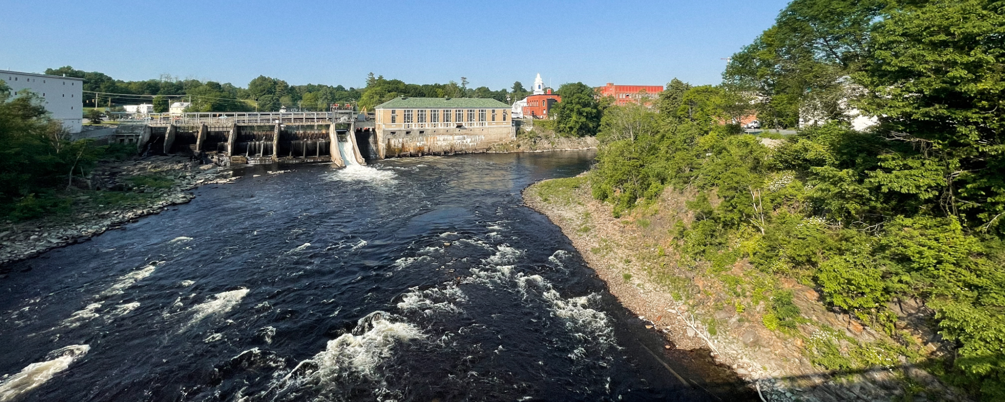 A river lined by historic mill buildings