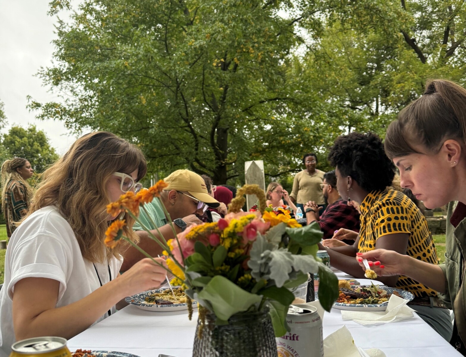 People sitting at a table outdoors enjoying a fresh farm to table meal