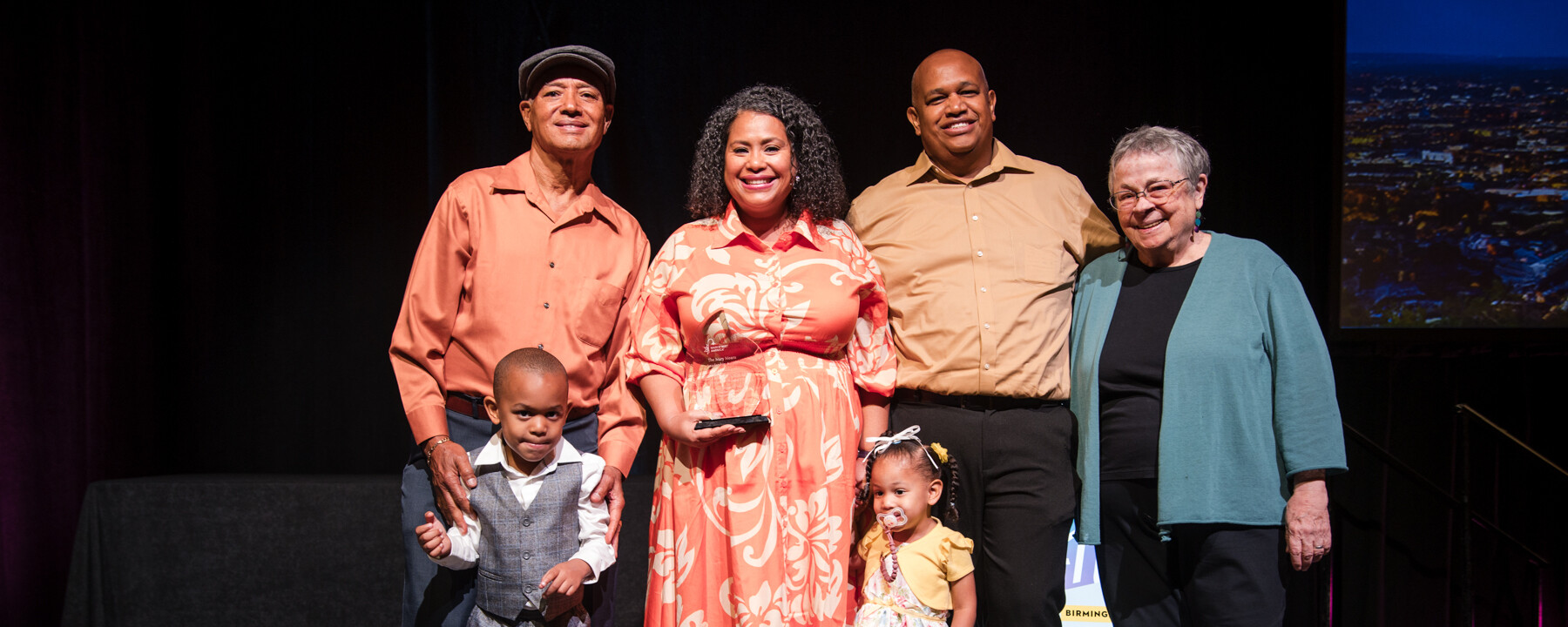 Mileyka Burgos-Flores (center) and her family with Mary Means (right).