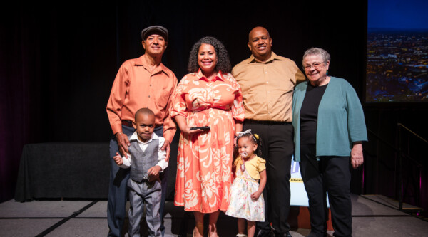 Mileyka Burgos-Flores (center) and her family with Mary Means (right).