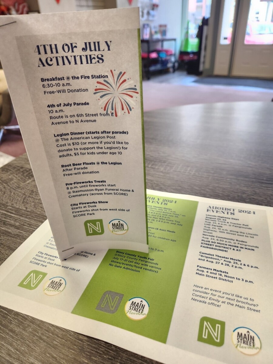 A folded paper standing up on a table printed with a calendar of local events