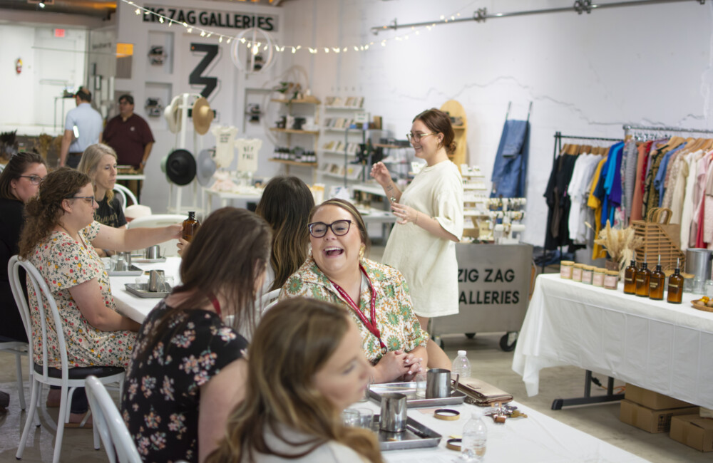 Women sit at tables during a Main Street training event