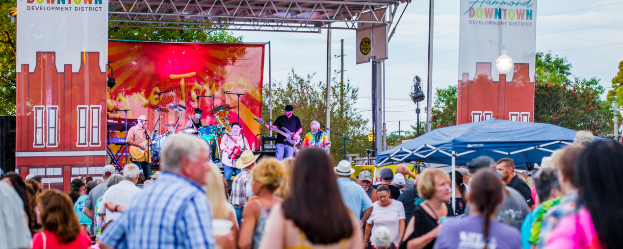 A large crowd listening to music at a free outdoor live music event