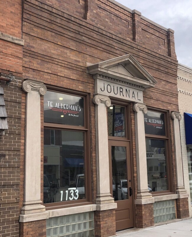 Historic brick building with Greek architectural accents