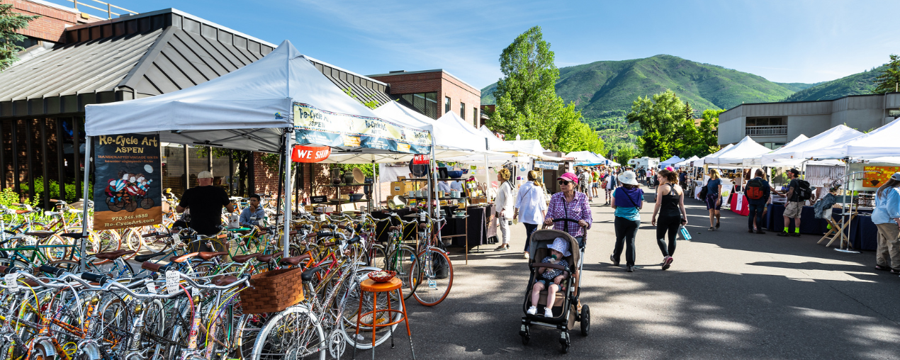 People shopping at an outdoor farmers market