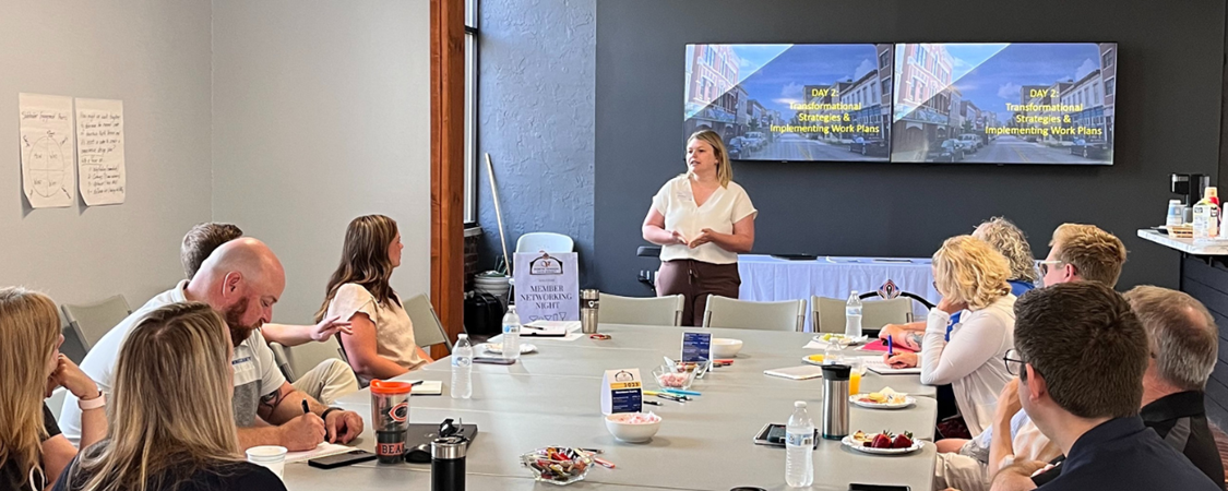 A group of people in a conference room listening to a presentation