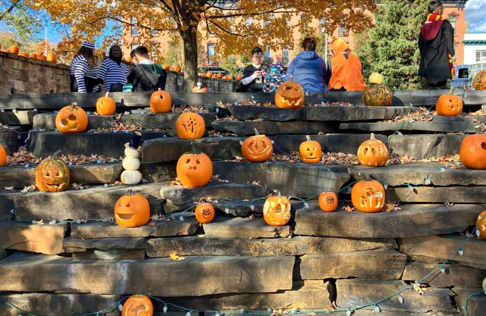 Carved and painted Halloween pumpkins on concrete steps in a downtown park