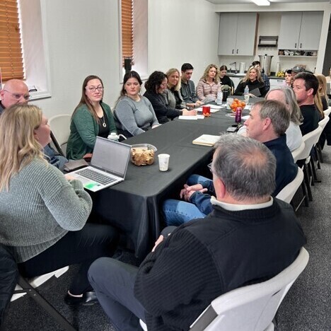 A group of people sitting at a conference table during a meeting