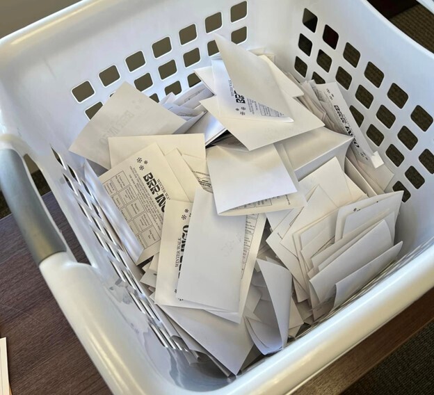 A laundry basket full of folded paper bingo cards