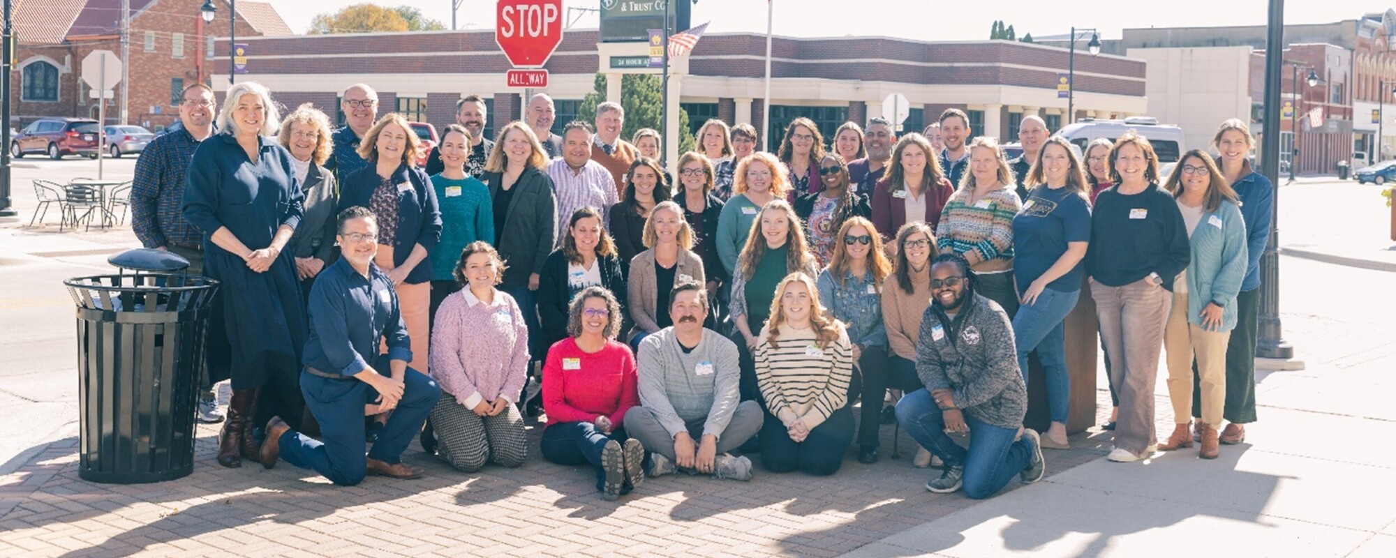 A large group of people posing on the sidewalk in Nevada, Iowa