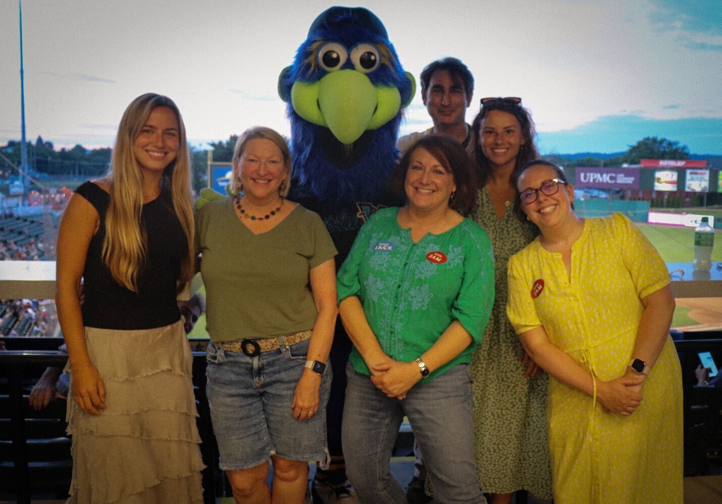 A group of people pose with a sports mascot