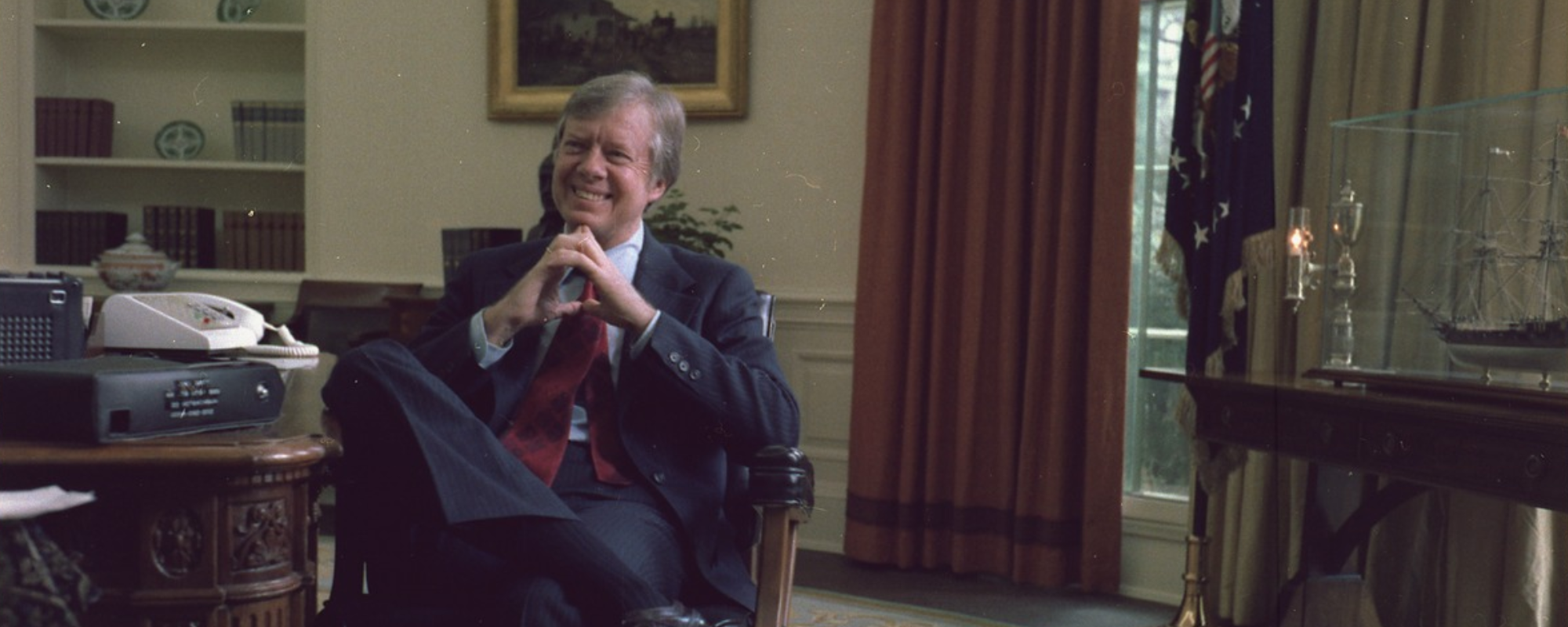 Jimmy Carter sitting at a desk in the Oval Office