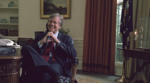 Jimmy Carter sitting at a desk in the Oval Office