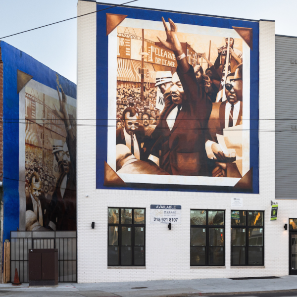 Historic brick buildings. One of them features a mural of MLK Jr.