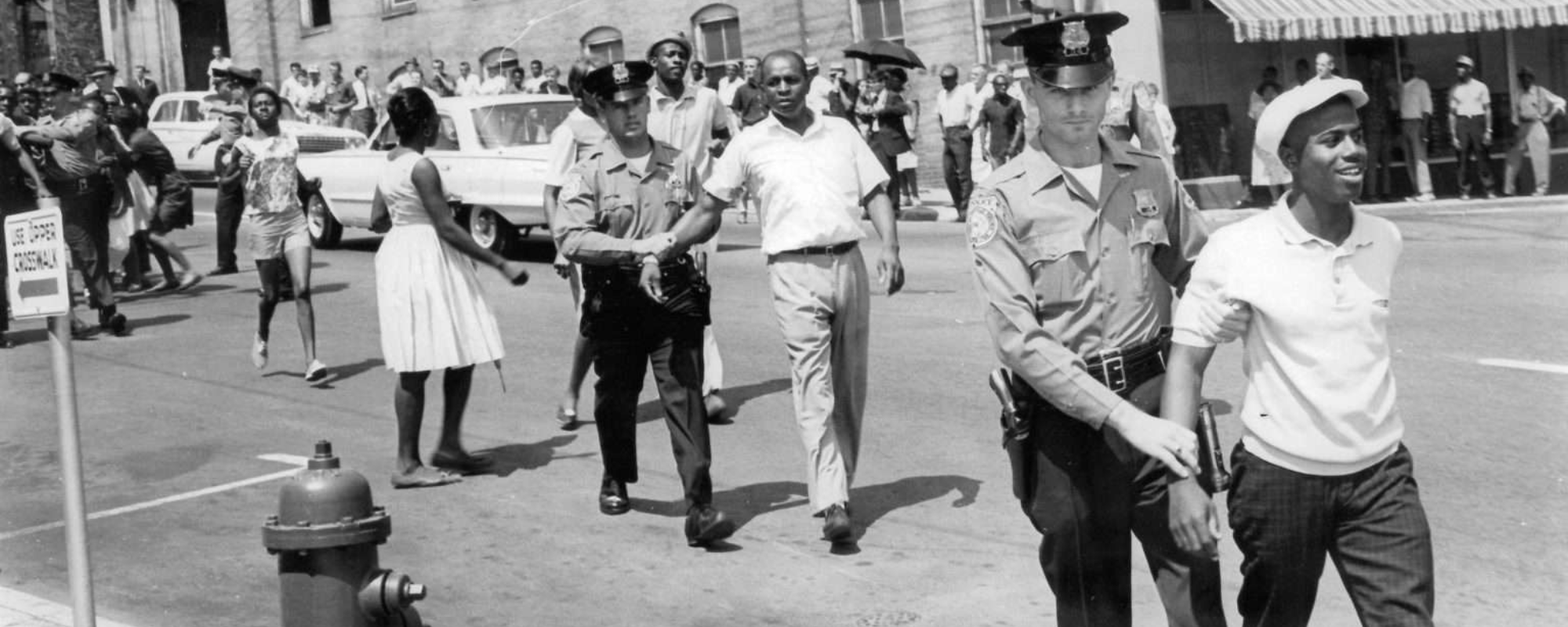 Black and white photo of protesters being arrested