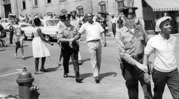 Black and white photo of protesters being arrested