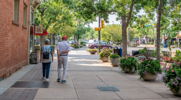 An elderly couple exploring a beautiful historic downtown