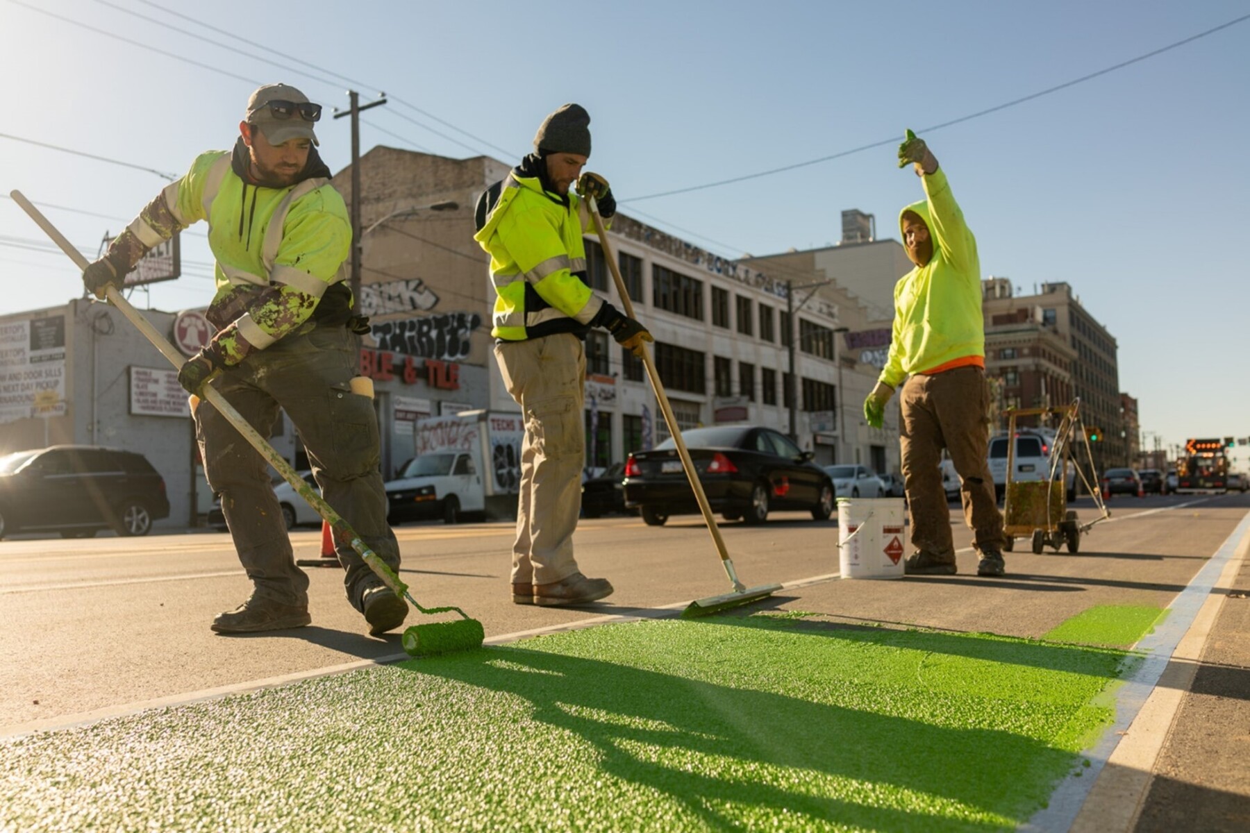 City workers painting markings on a street