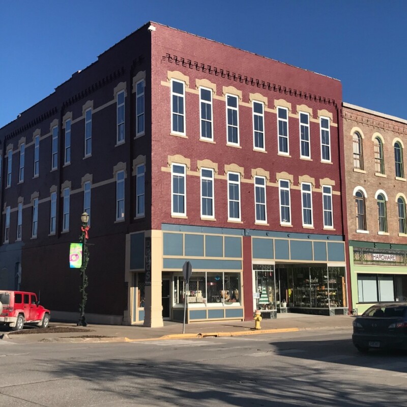 After photo of a historic building with red paint