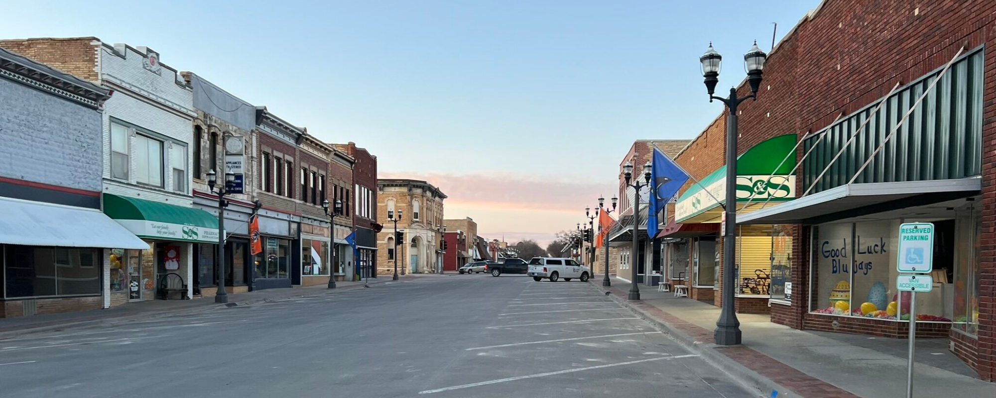 Historic brick buildings lining Main Street in small town.