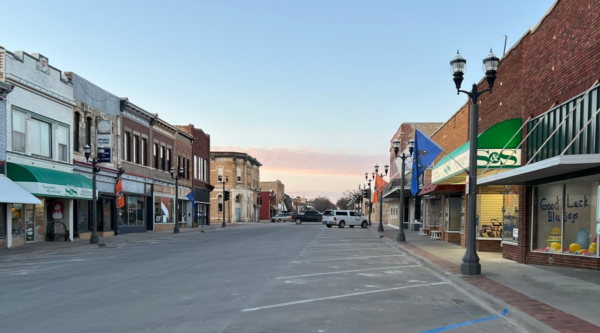 Historic brick buildings lining Main Street in small town.