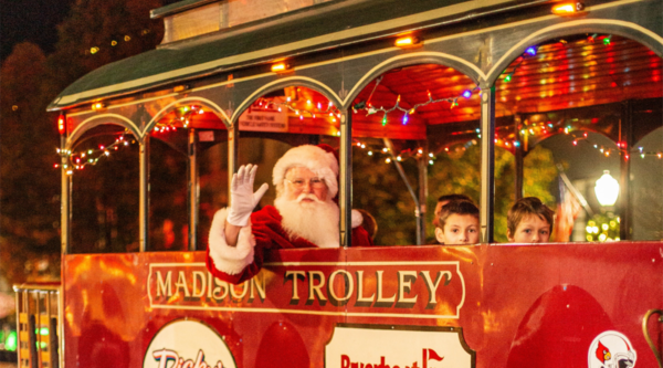 Santa riding a red street trolley