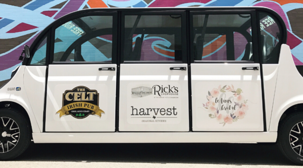 Large electric shuttle with downtown branding