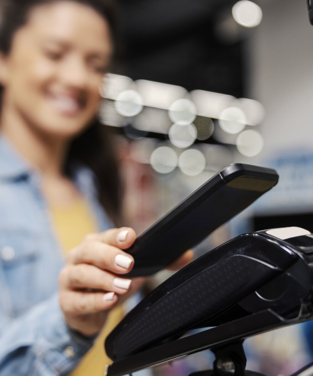 a woman making a payment with her phone
