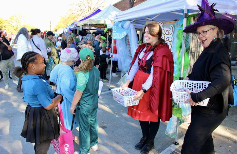 Children in different costumes participate in a trick or treat event