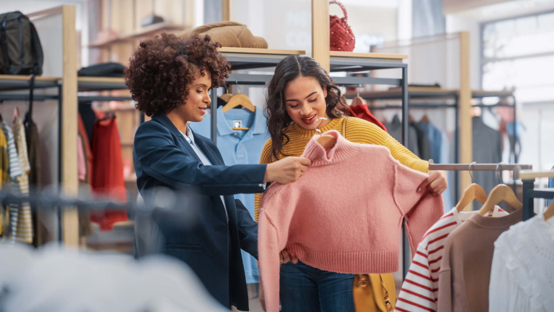 Two women shopping for clothing in a retail store