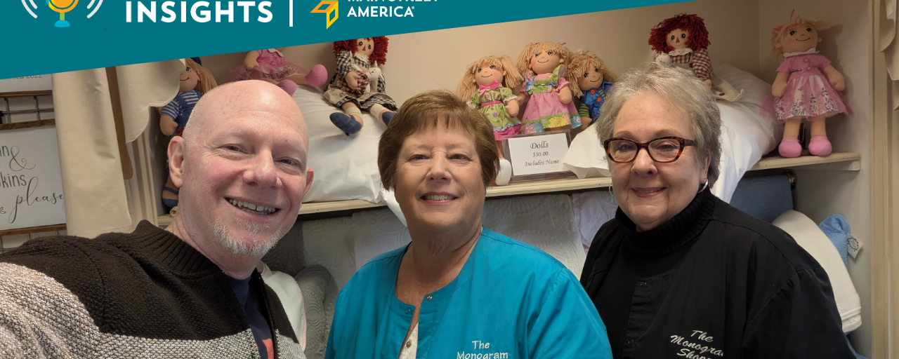 Man posing with two women in front of store display