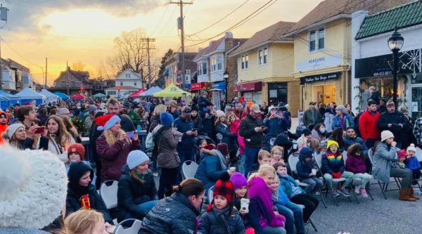 A crowd of people on a downtown street in winter