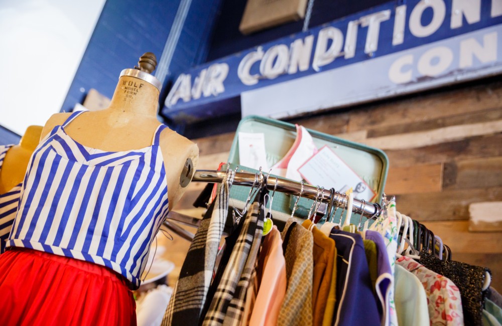Clothing rack and mannequins displaying eclectic clothing.