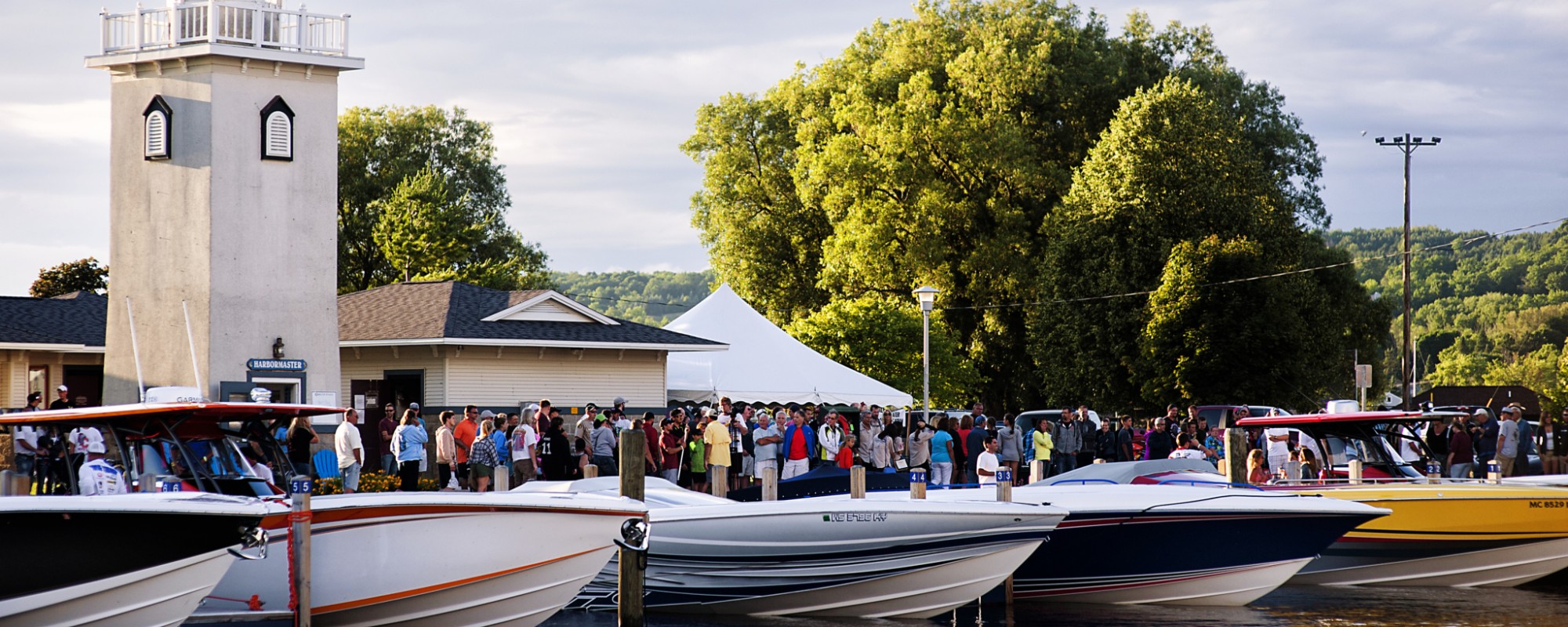 Boats lined up at docks on a lake.