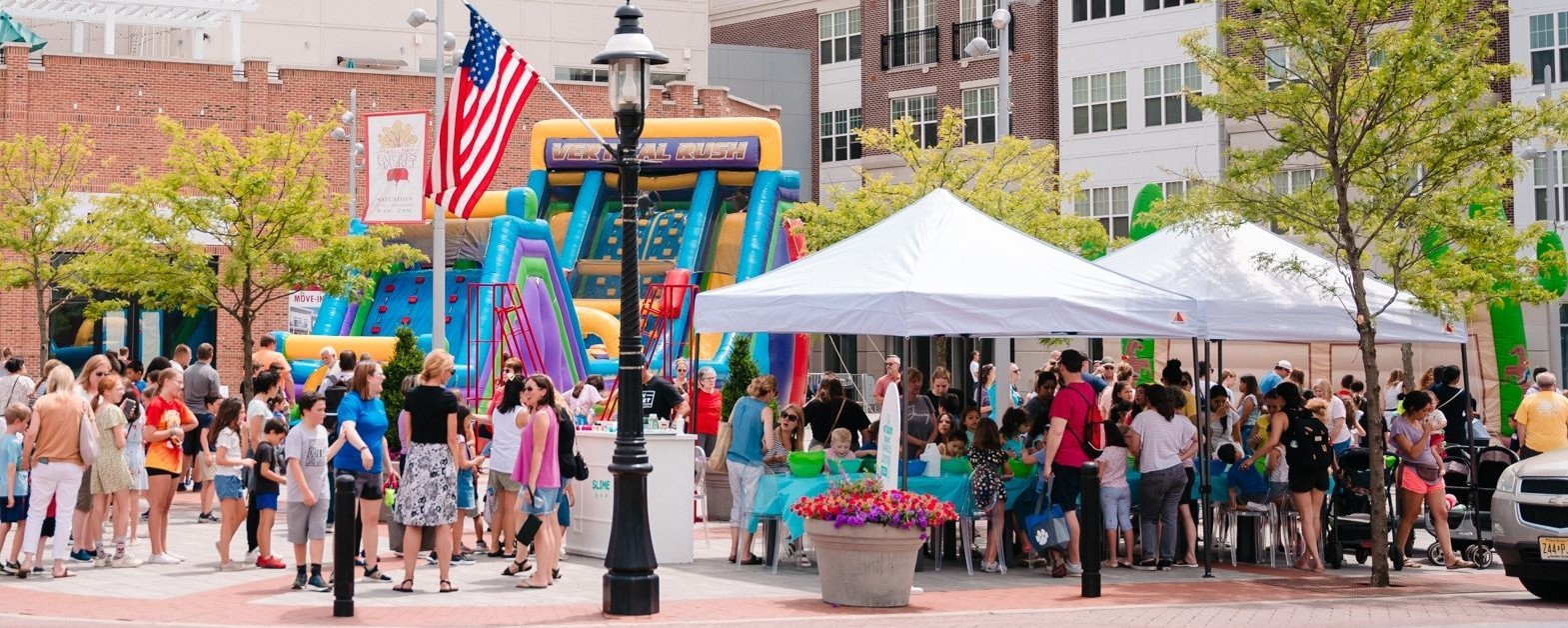 People gather and vendor booths are set-up in a plaza for spring bazaar event.