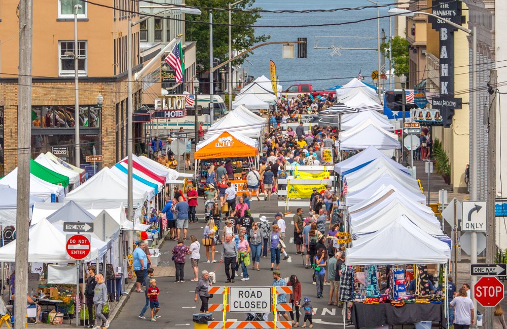People walk in a closed street filled with tents