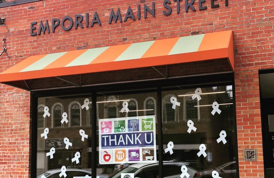 A brick building with a large window that displays a sign reading "Thank U."