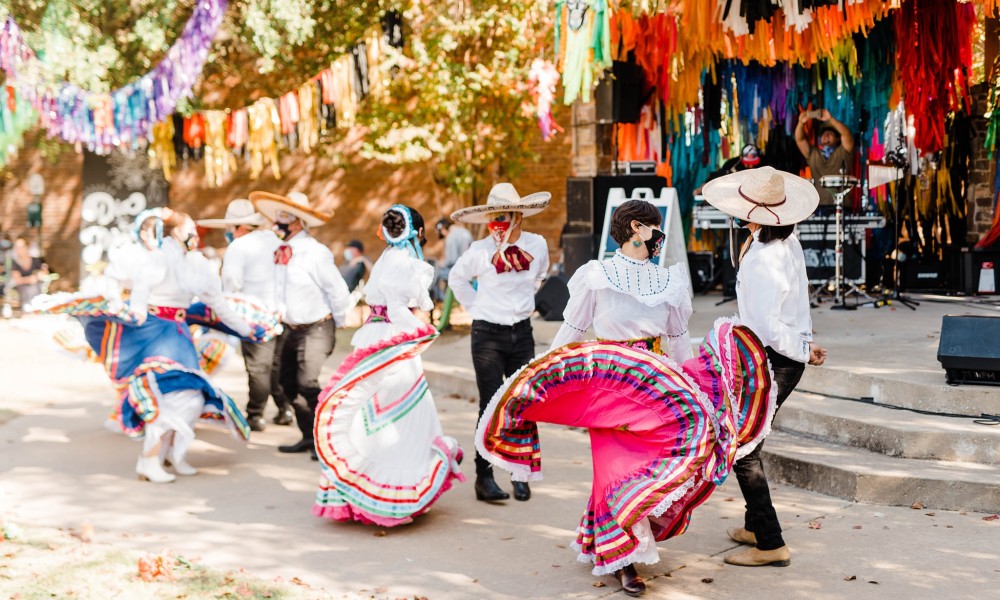 Performers in traditional dress at a Dia de los Muertos celebration.