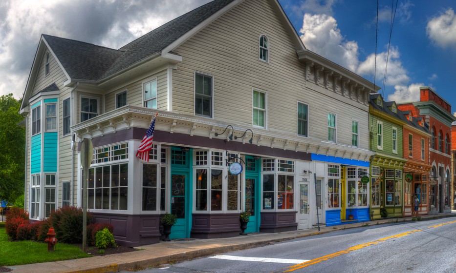 Brightly colored historic buildings line a narrow street.