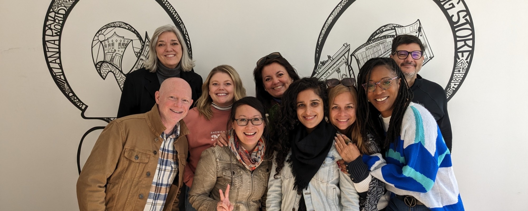 Field Services team poses in front of artwork in Atlanta, Georgia.