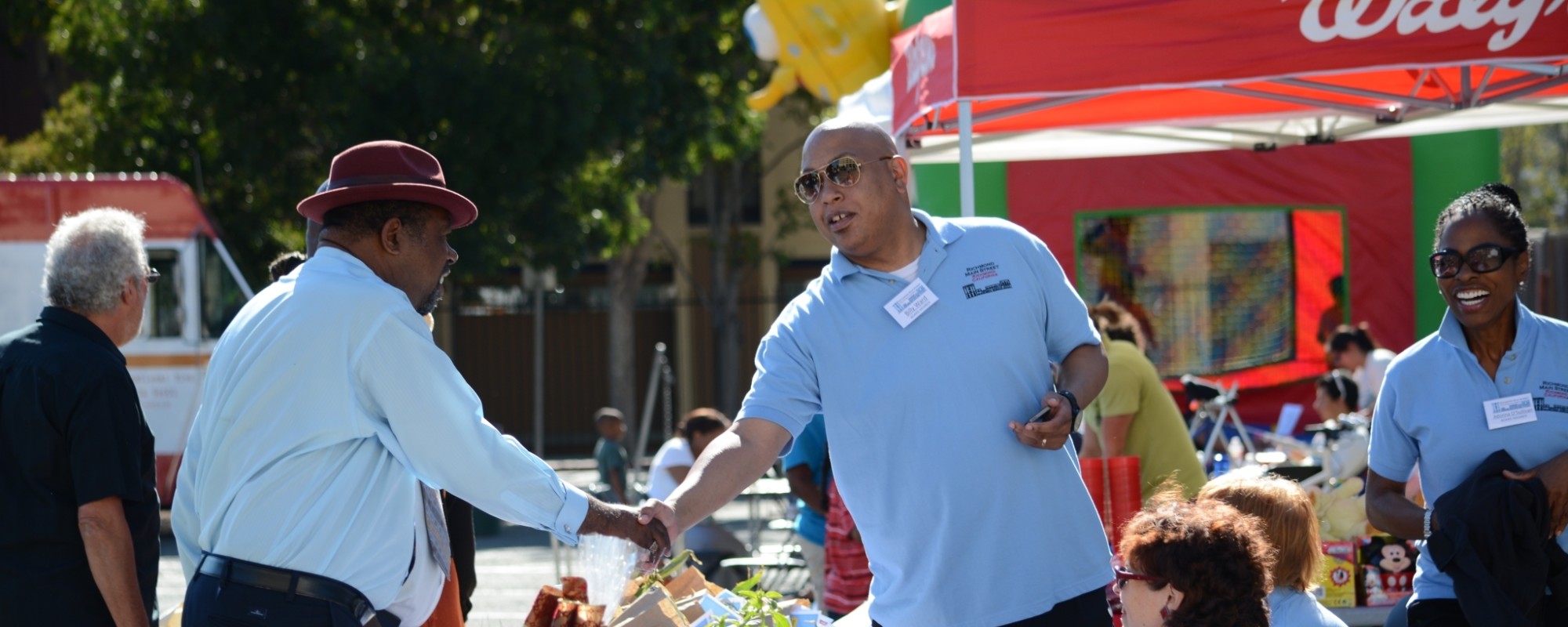 Men shaking hands at a community event.