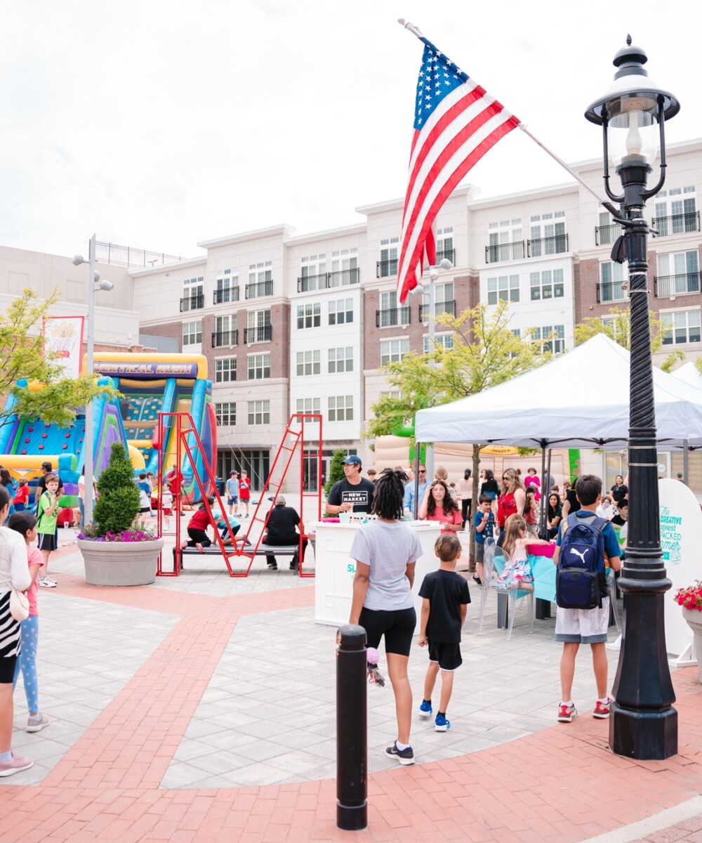 People attend a street fair in an activated downtown plaza