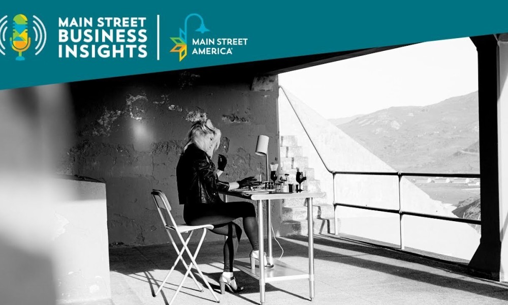 Black and white photo of woman sitting at desk