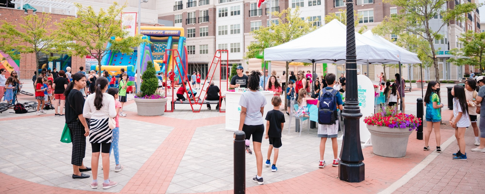 People attend a street fair in an activated downtown plaza