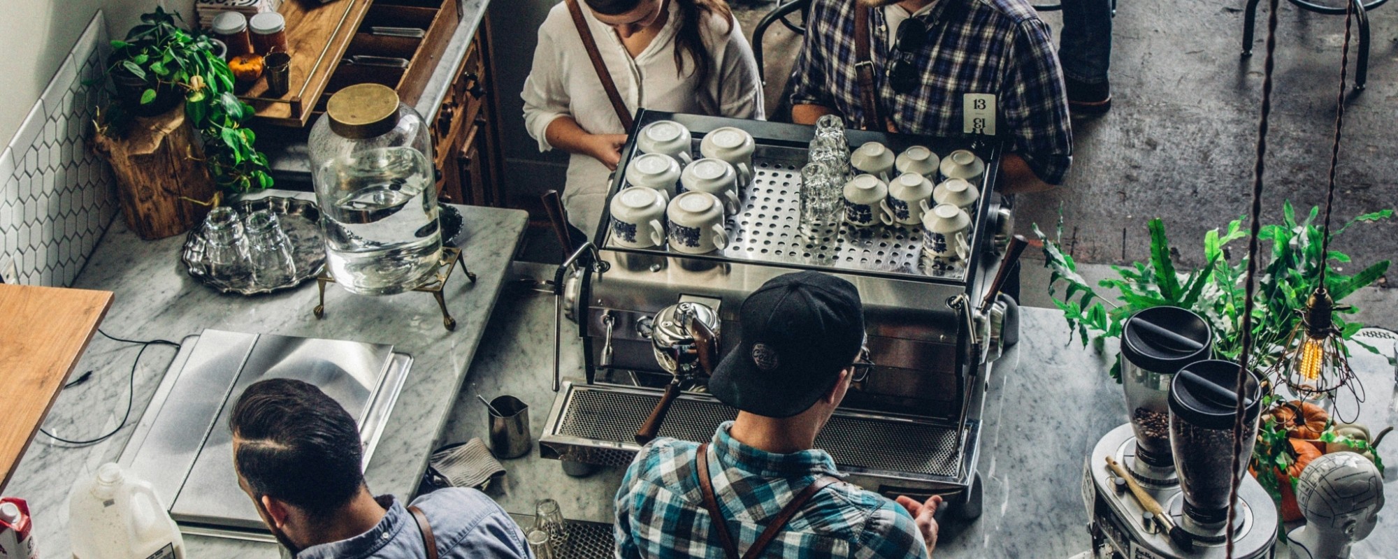 Overhead shot of people ordering coffee in a small cafe