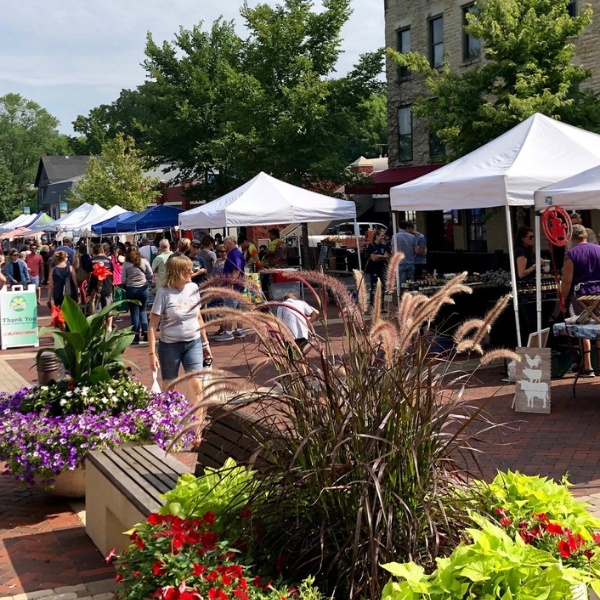 People enjoying an outdoor downtown market