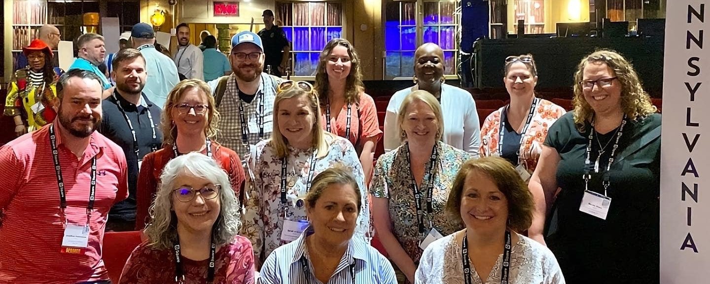 A group of people posing in a historic theater