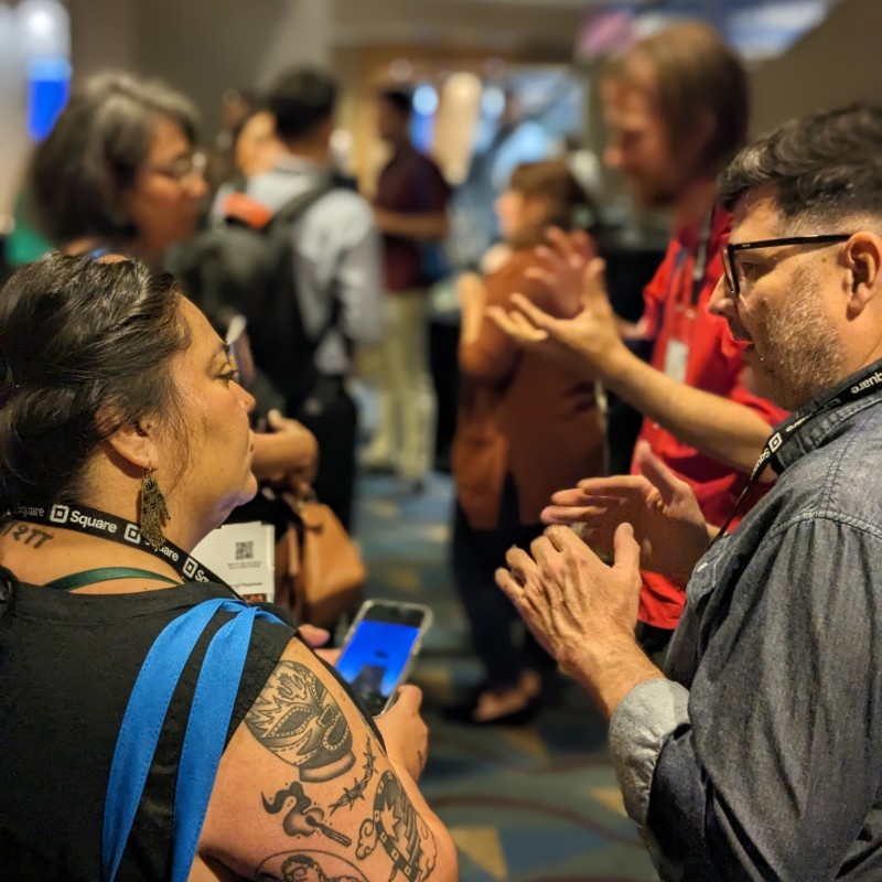 Two people engaged in conversation during a networking event.